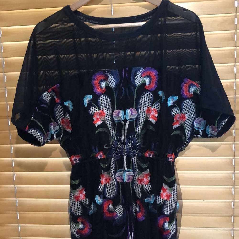 Black mesh dress with embroidered flowers.
